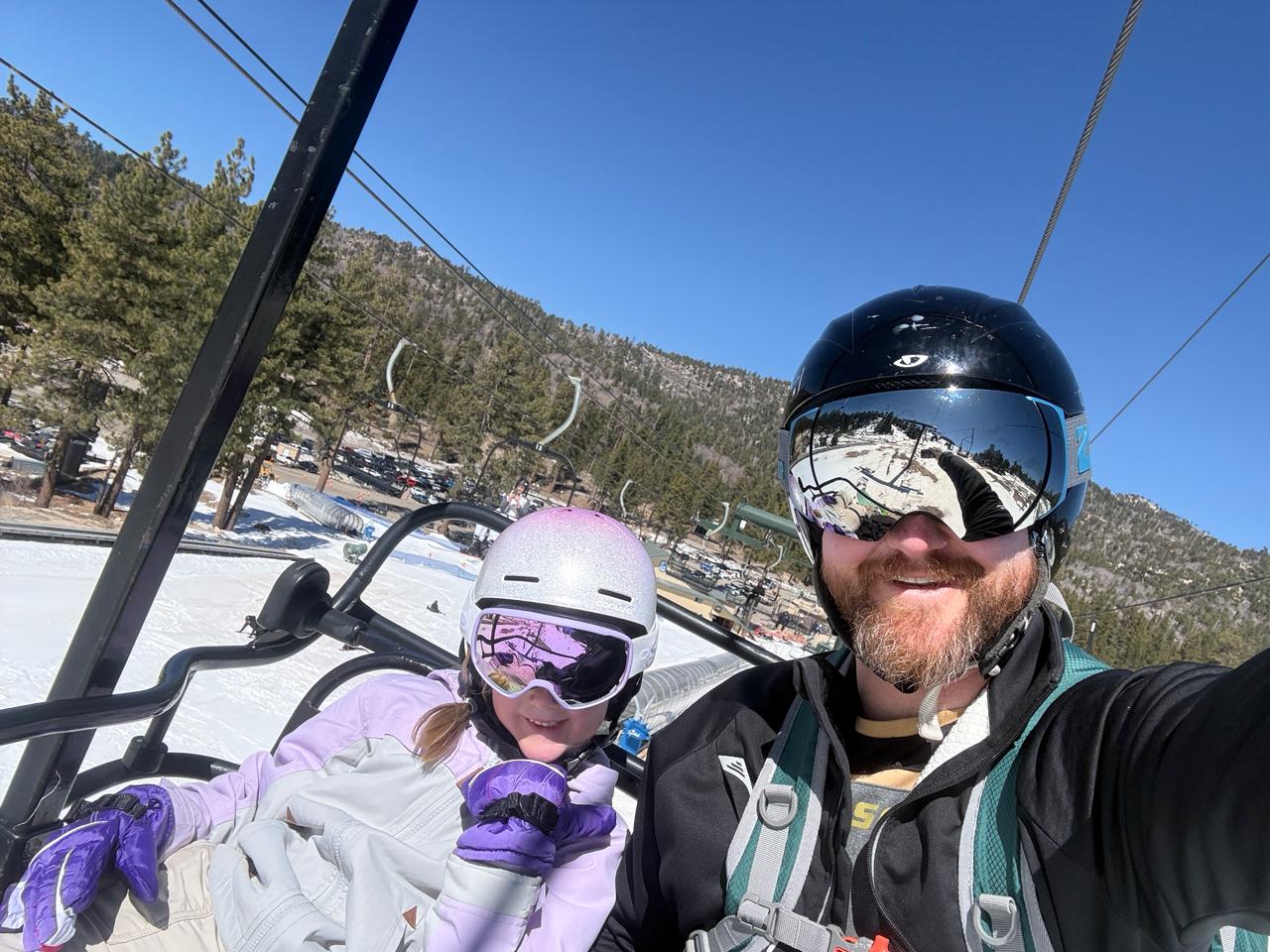 Alex and daughter on a ski lift